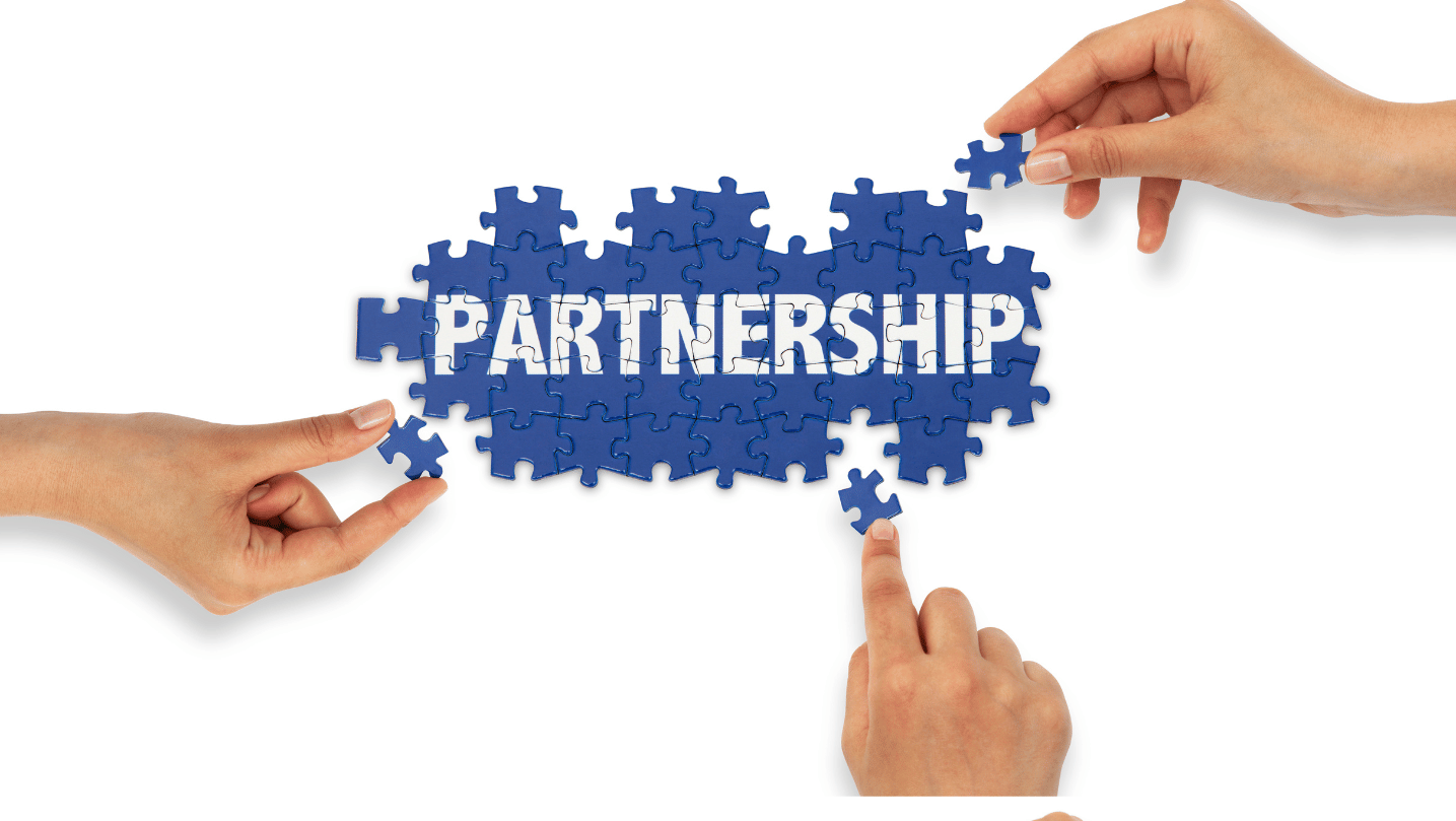 Hands fininshing the puzzle with 'PARTNERSHIP' text